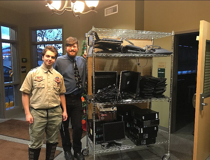 Courtesy photo
Marcus Thomas, 18, left, and his mentor, Jason McDonald, stand with the 14 computers Thomas fixed and gifted to the Union Gospel Mission Center for Women and Children in Coeur d&#146;Alene on Nov. 20. The machines will go home with program graduates to help them with job searches and furthering education as they build better lives for themselves and their children.