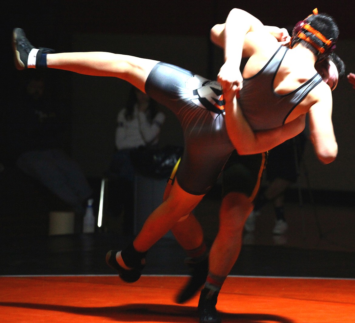 Rodney Harwood/Columbia Basin Herald
Quincy's Ray Robinson (back) throws Alan Maceda of Ephrata in the 182-pound match Thursday night in Ephrata.