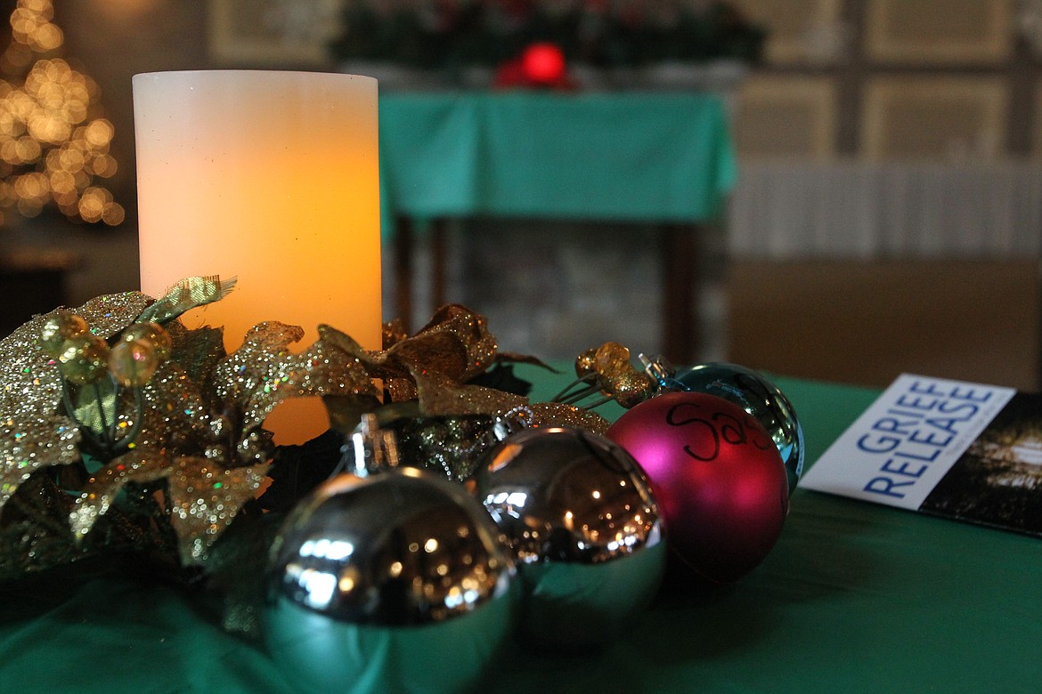 Many who attended the Ceremony of Remembrance in Lake City Church on Saturday wrote the names of loved ones who have passed on ornaments that were placed on Christmas trees. &#147;Love never dies,&#148; said ceremony organizer Joanie Dwyer. (DEVIN WEEKS/Press)