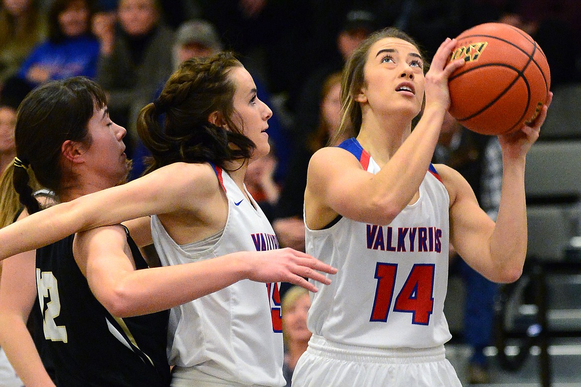 Bigfork's Abby Ellison (14) looks to shoot in front of teammate Heidi Schneller (15) and Seeley-Swan defender Klaire Kovatch (12). (Casey Kreider/Daily Inter Lake)