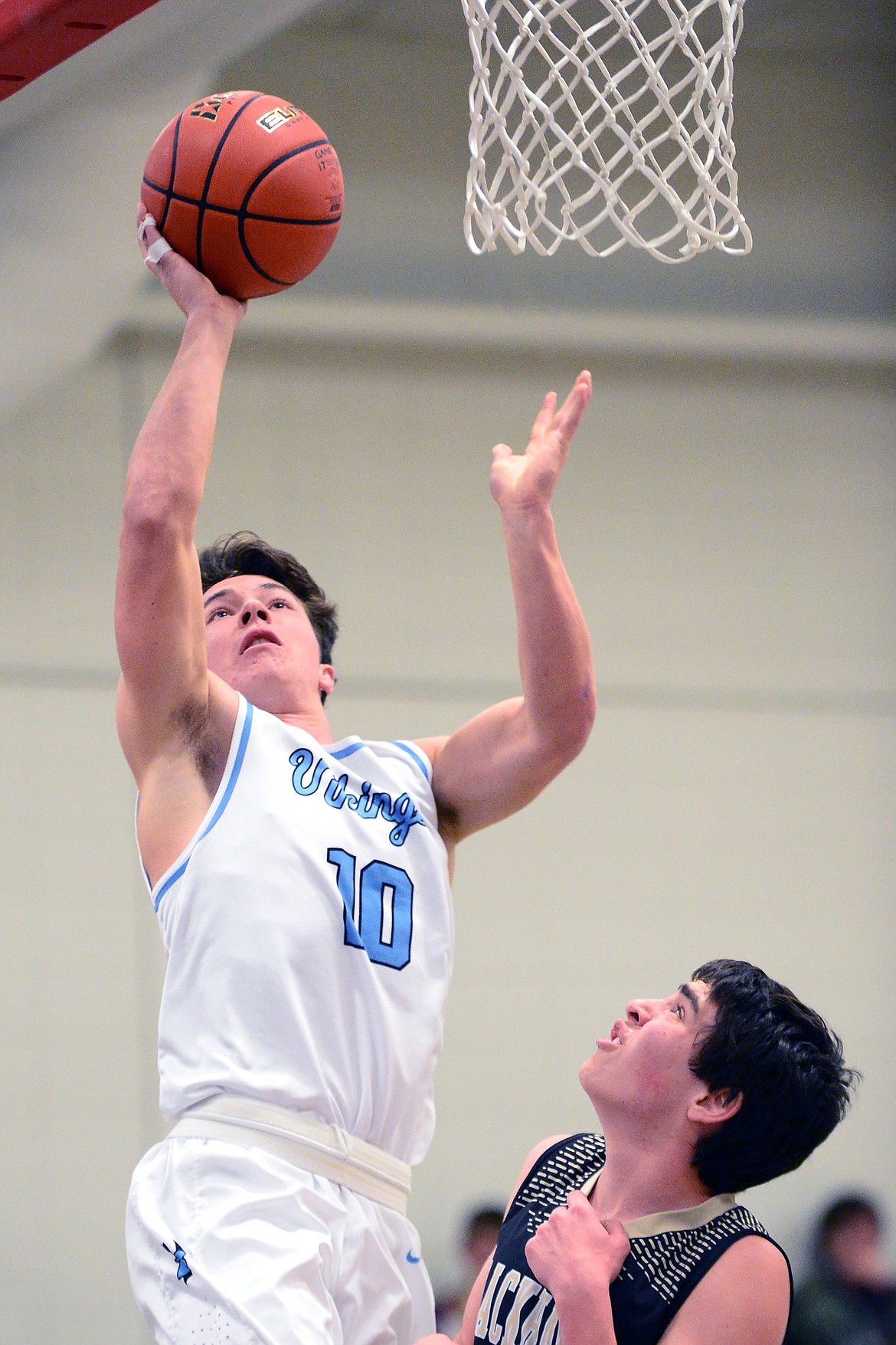 Bigfork's Randy Stultz goes to the hoop with Seeley-Swan's Cameron Haines defending. (Casey Kreider/Daily Inter Lake)