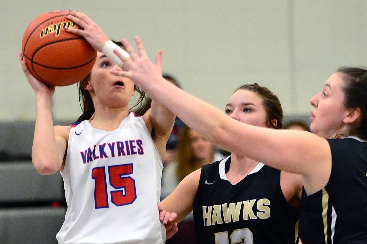 Bigfork's Heidi Schneller shoots against Seeley-Swan defenders Emily Howard (13) and Jory Towe (21) in the first half Tuesday night.