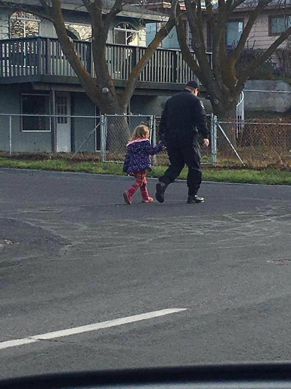 Moses Lake Police Department/courtesy photo
A Moses Lake officer makes contact with a 4-year-old girl who was spotted walking alone in the city on Monday.