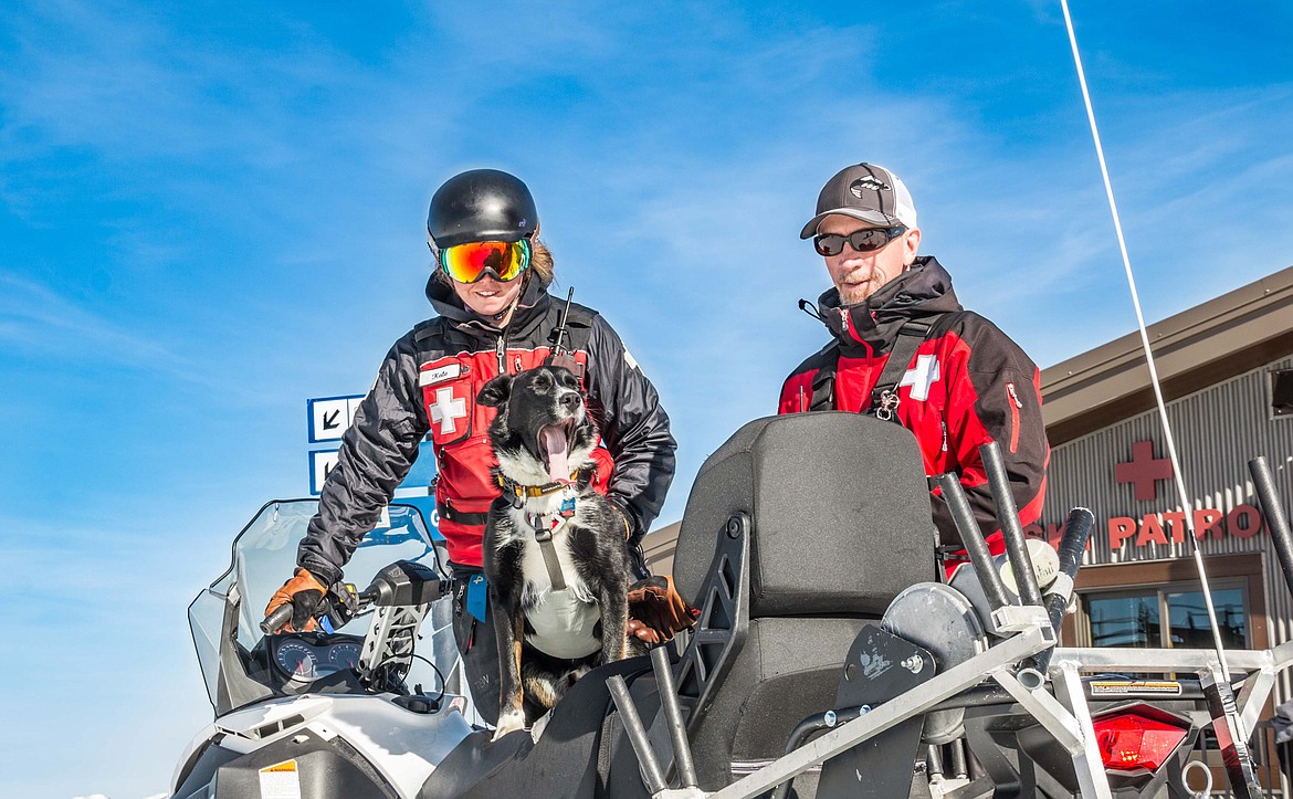 Kate Atha and Lloyd Morsett, with avalance dog, Jet, are pictured on Whitefish Mountain Resort. (Photo courtesy of Whitefish Mountain Resort)