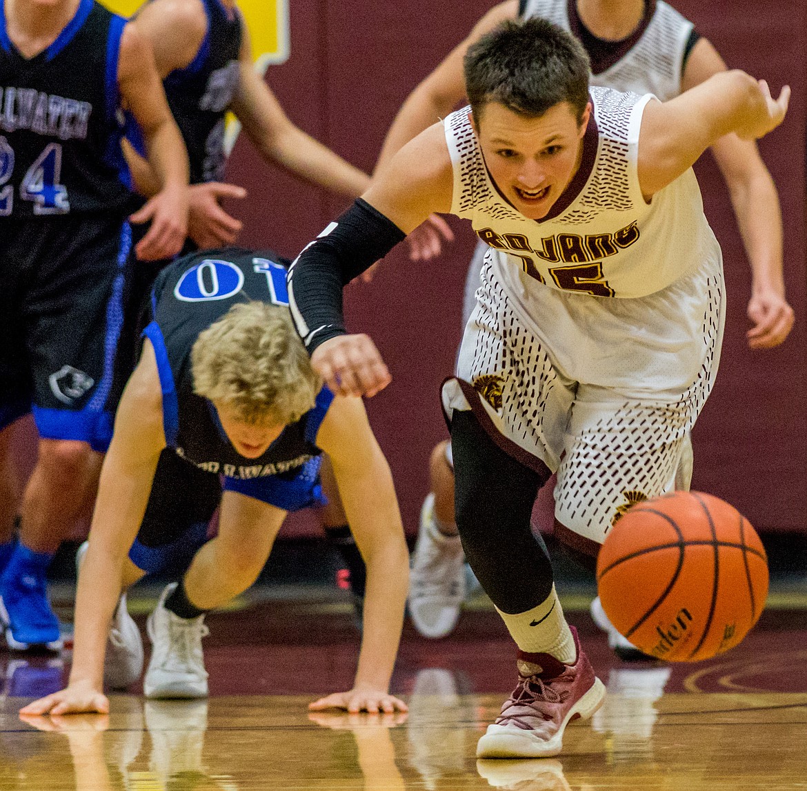 Troy&#146;s Logan Milde chases a loose ball that got away from Stillwater&#146;s Connor Drish Tuesday in Troy. (John Blodgett/The Western News)