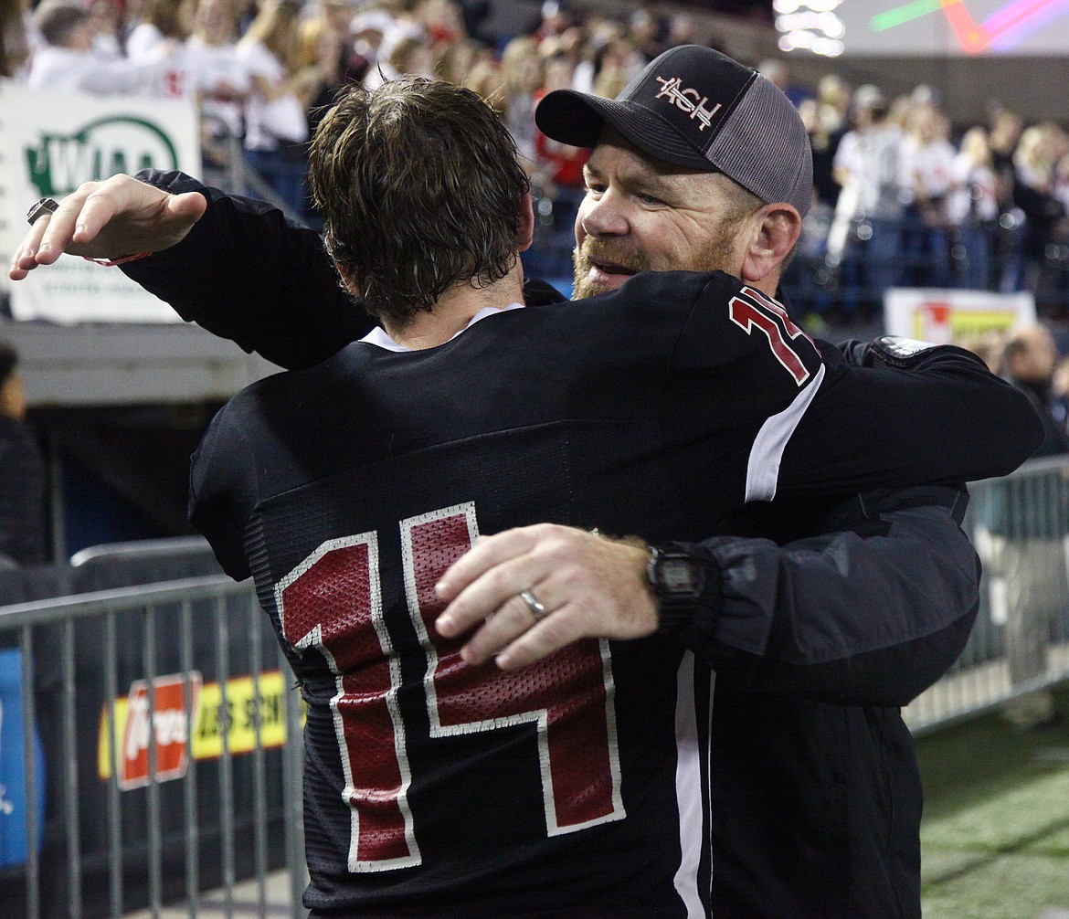 Rodney Harwood/Columbia Basin HeraldAlmira/Coulee-Hartline coach Brandon Walsh gives quarterback Maguire Isaak a hug after the Warriors won their second 1B state championship in three years Friday at the Tacoma Dome.