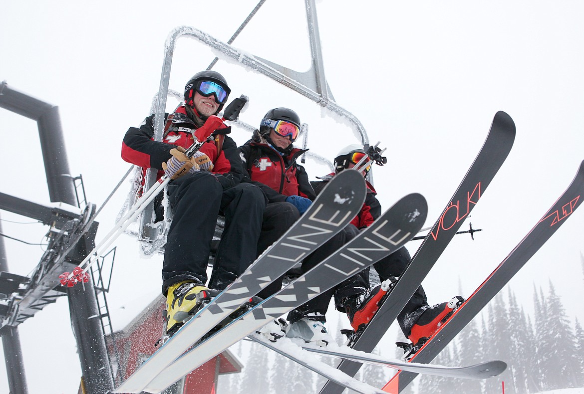 Whitefish Mountain Resort ski patrollers head up the recently opened chair 5 on opening day, Dec. 7. (Mackenzie Reiss/Daily Inter Lake)