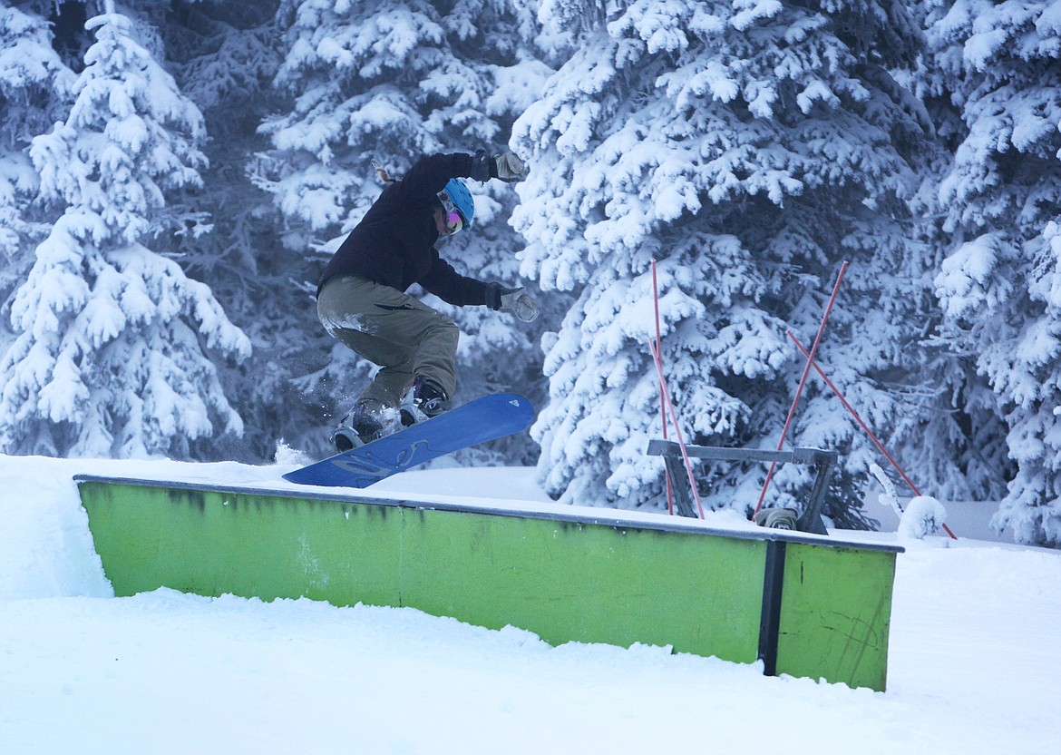 A snowboarder jumps onto a box in the terrain park on Whitetail Thursday, Dec. 7. (Mackenzie Reiss/Daily Inter Lake)