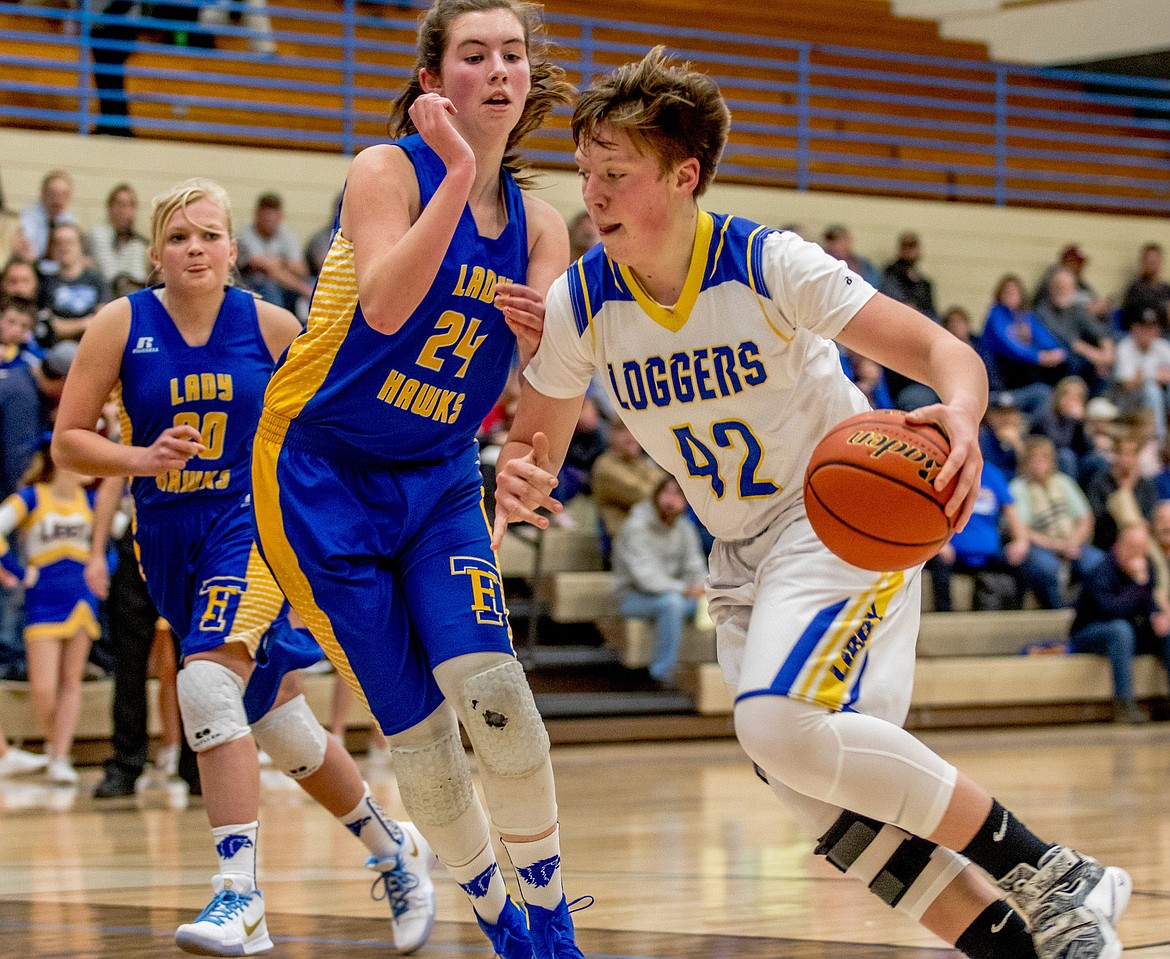 Libby&#146;s Shannon Reny drives for the basket under guard of Thompson Falls&#146; Megan Baxter Saturday. (John Blodgett/The Western News)