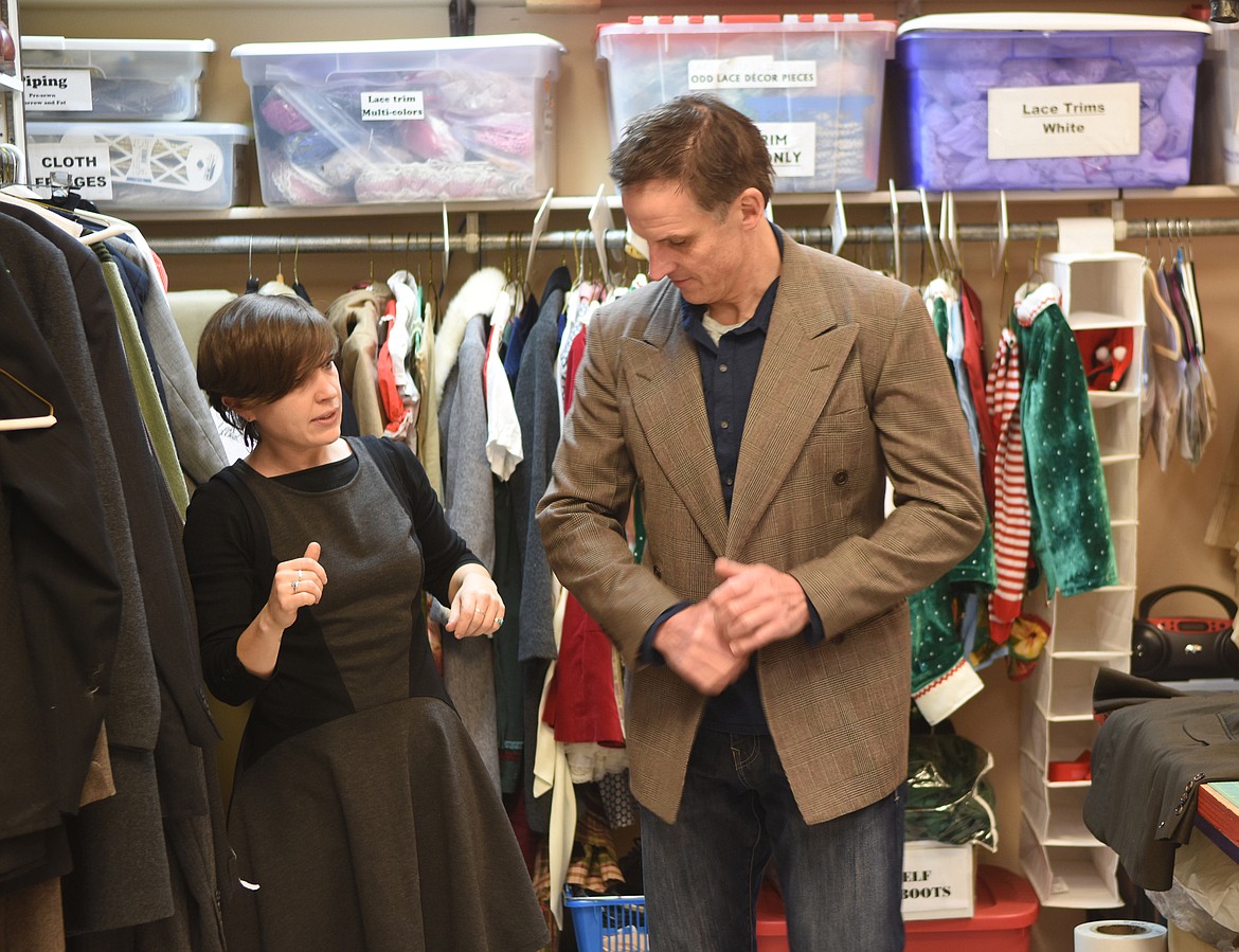 Sarah Bell assists actor Andrew Matulionis in trying on a suit jacket last week in the costume room at the O&#146;Shaughnesy Center. (Heidi Desch/Whitefish Pilot)