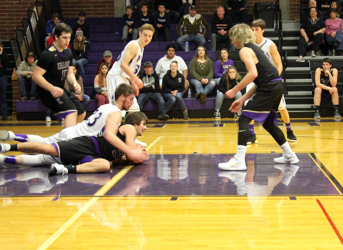 Tiger Gryphon Todd and Wildcat Chris Jennings battle for a loose ball as Jennings tries to get the ball to Tyler Gibbons.