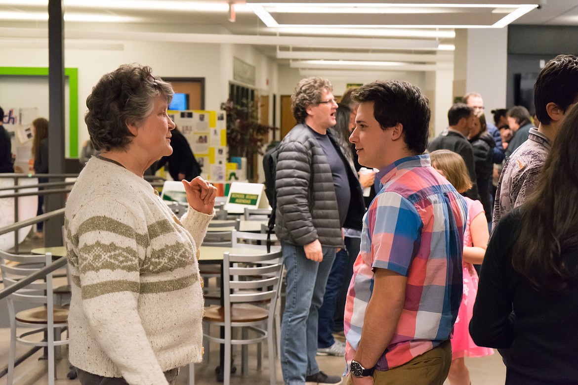 Trustee Ruth Harrison chats with Zach Ade during an event at Whitefish High School celebrating International Education Month.