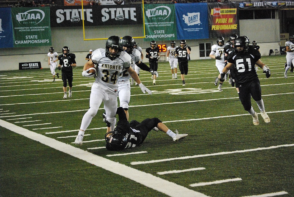 Bob Kirkpatrick/The Sun Tribune - Alonso Hernandez bowls over a Trojan defender after a long gain in the fourth quarter of the game. Hernandez finished with 148 yards on 24 carries and three touchdowns.