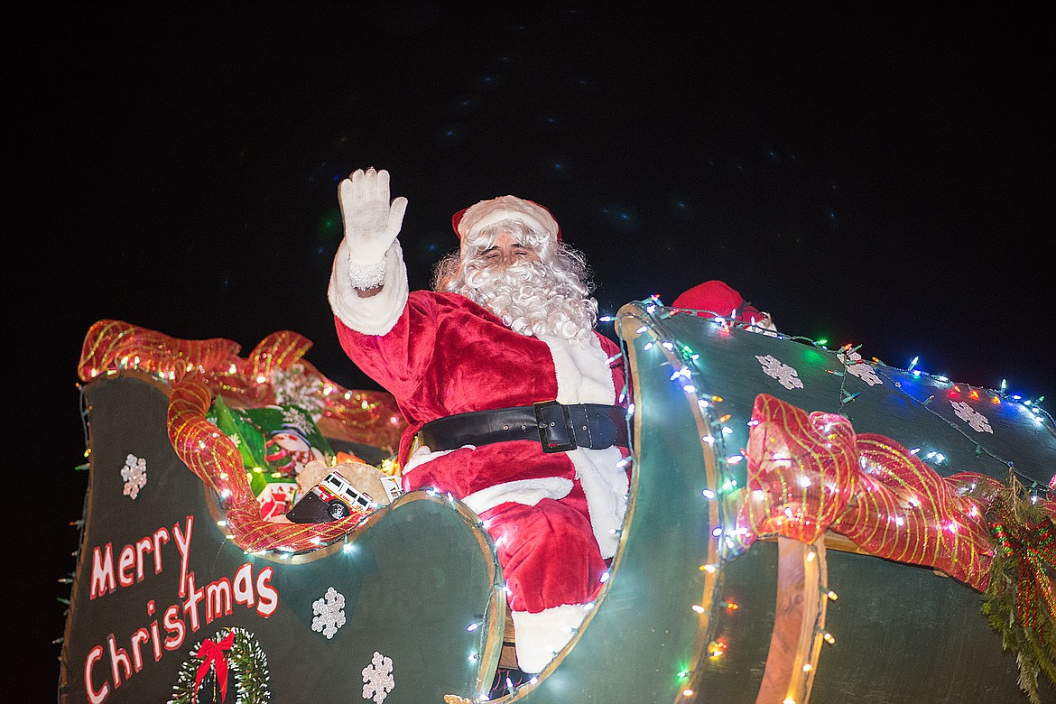 Santa Claus waves to the crowd.