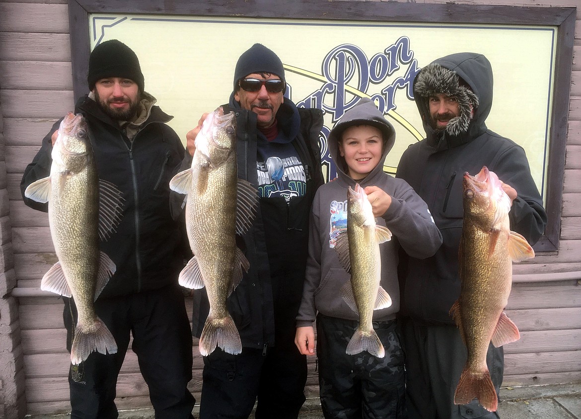 Pete Fisher photo - From Left to Right Jason Groskreutz, Rob Wysong, Payton Wyson, and Josh Plante of Spokane show a great morning's catch of Potholes Reservoir walleye. They used 1/2 oz. blade baits in 20-35 feet of water.