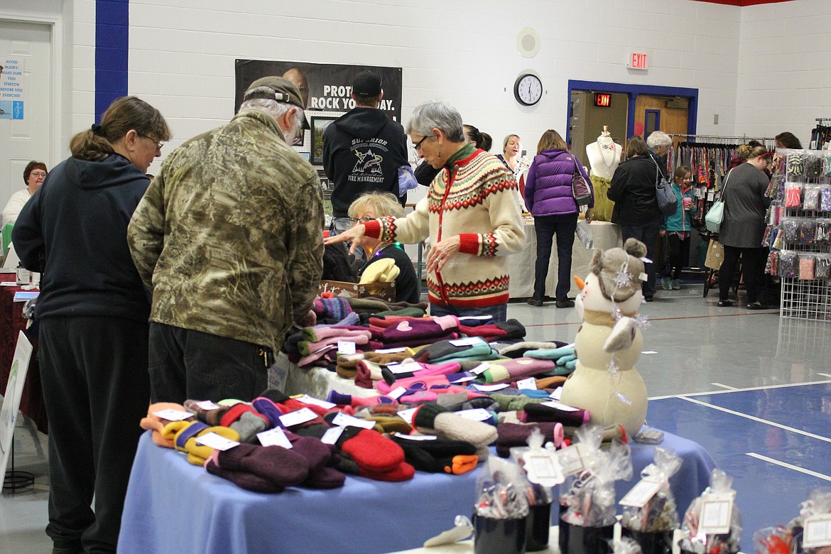 Connie Acker shows her collection of warm mitten made from recycled sweaters during the craft bazaar on Saturday. (Kathleen Woodford/Mineral Independent).