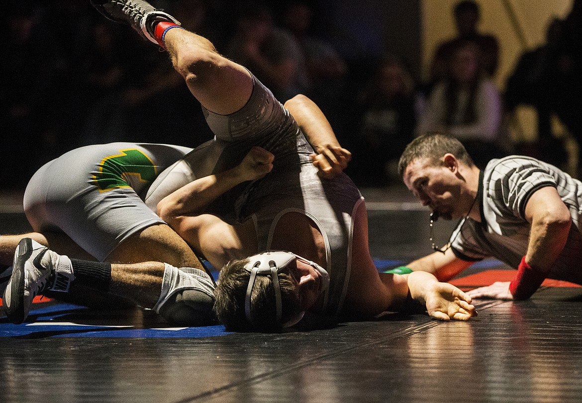 Lakeland&#146;s Larry Johnson rolls over Riley Cisne shortly before pinning him in the 145-pound final Tri-State match at North Idaho College. 
LOREN BENOIT/Press