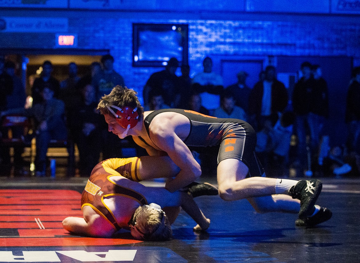 LOREN BENOIT/Press

Post Falls&#146; Braydon Huber rolls over Nate Moore&#146;s shoulder in the 152 pound Tri-State final match Saturday night at North Idaho College.