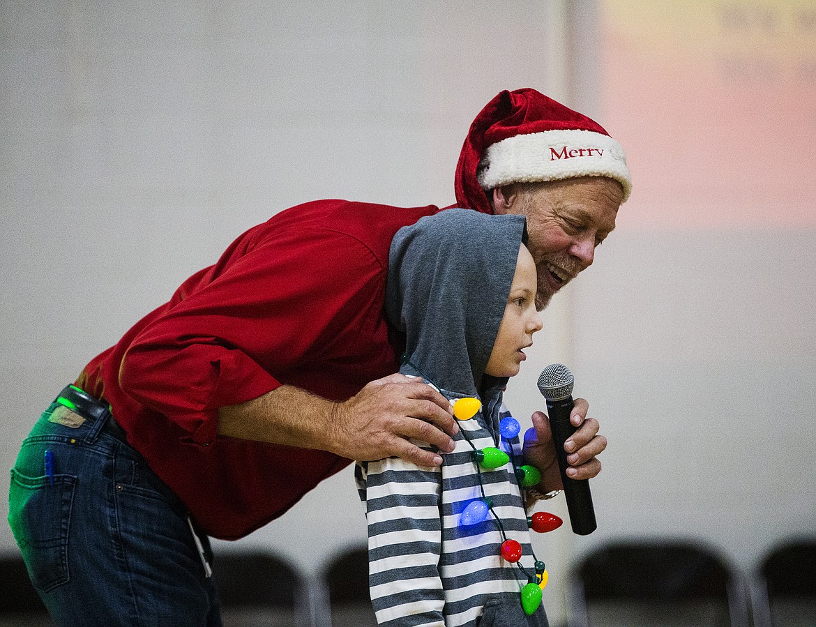 Dalton Elementary School Principal Jim Gray and first-grader Jackson Beckenhauer, who has Lymphatic Hodgkin's Lymphoma, wish family, friends and students a merry Christmas during the school's Christmas assembly.(LOREN BENOIT/Press)