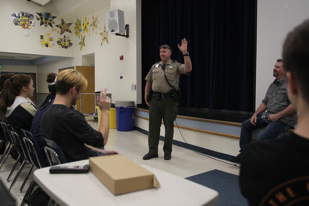 Kootenai County Sheriff's Dep. Solar Larsen connects with students Tuesday afternoon as he discusses his own personal experiences of being bullied as a kid. He briefly spoke during the Rachel's Challenge leadership meeting, presented by Larry Scott, the uncle of Rachel Scott, the first victim of the 1999 Columbine school shooting. The meeting was held to encourage Timberlake students to promote a culture of kindness in their school as they carry on Rachel's legacy of compassion. (DEVIN WEEKS/Press)