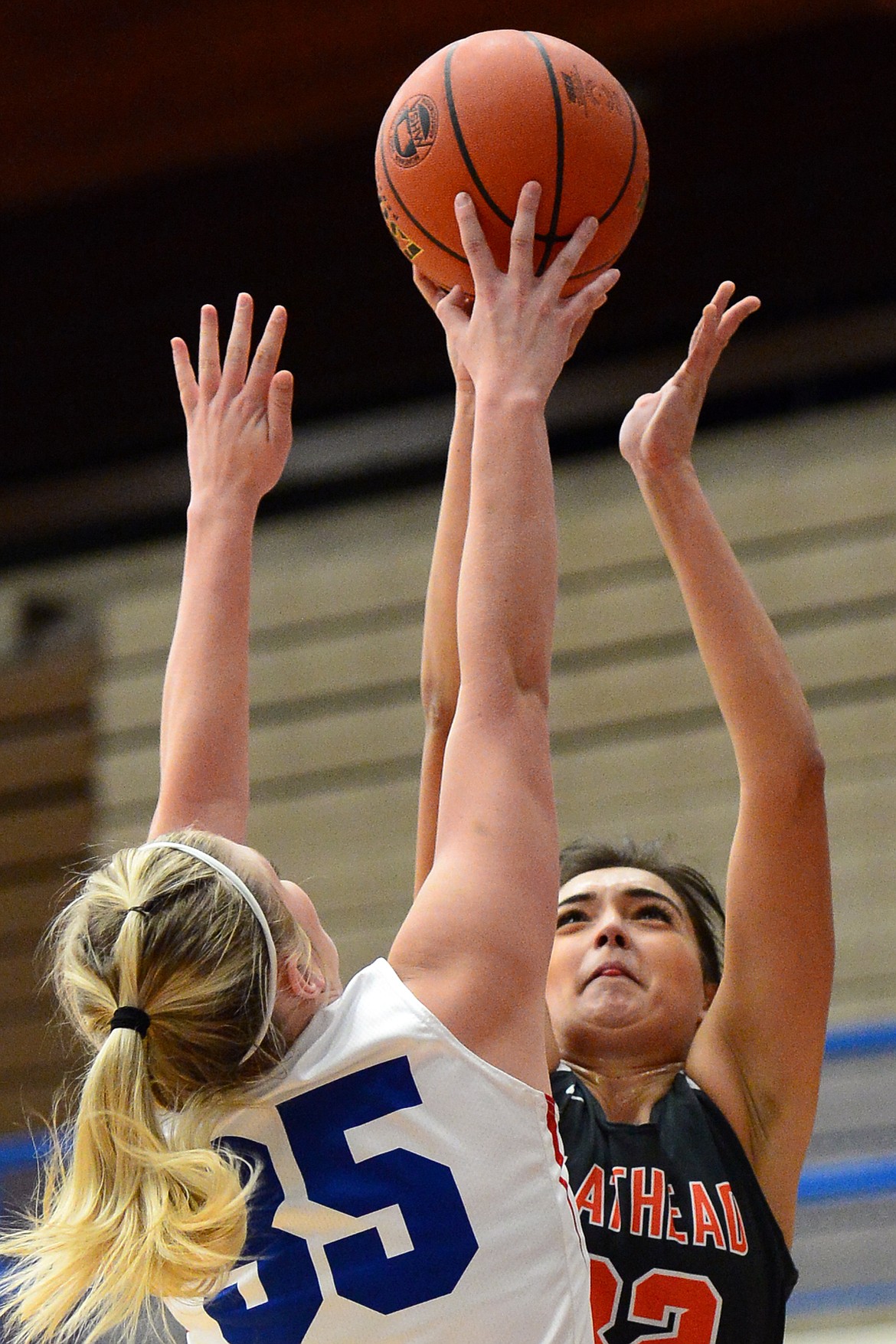 Flathead's Taylor Henley has her shot blocked by Columbia Falls' Trista Cowan. (Casey Kreider/Daily Inter Lake)