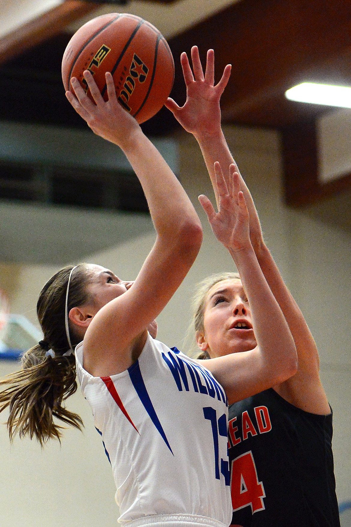 Columbia Falls' Hannah Gedlaman goes to the hoop with Flathead's Mary Heaton defending. (Casey Kreider/Daily Inter Lake)