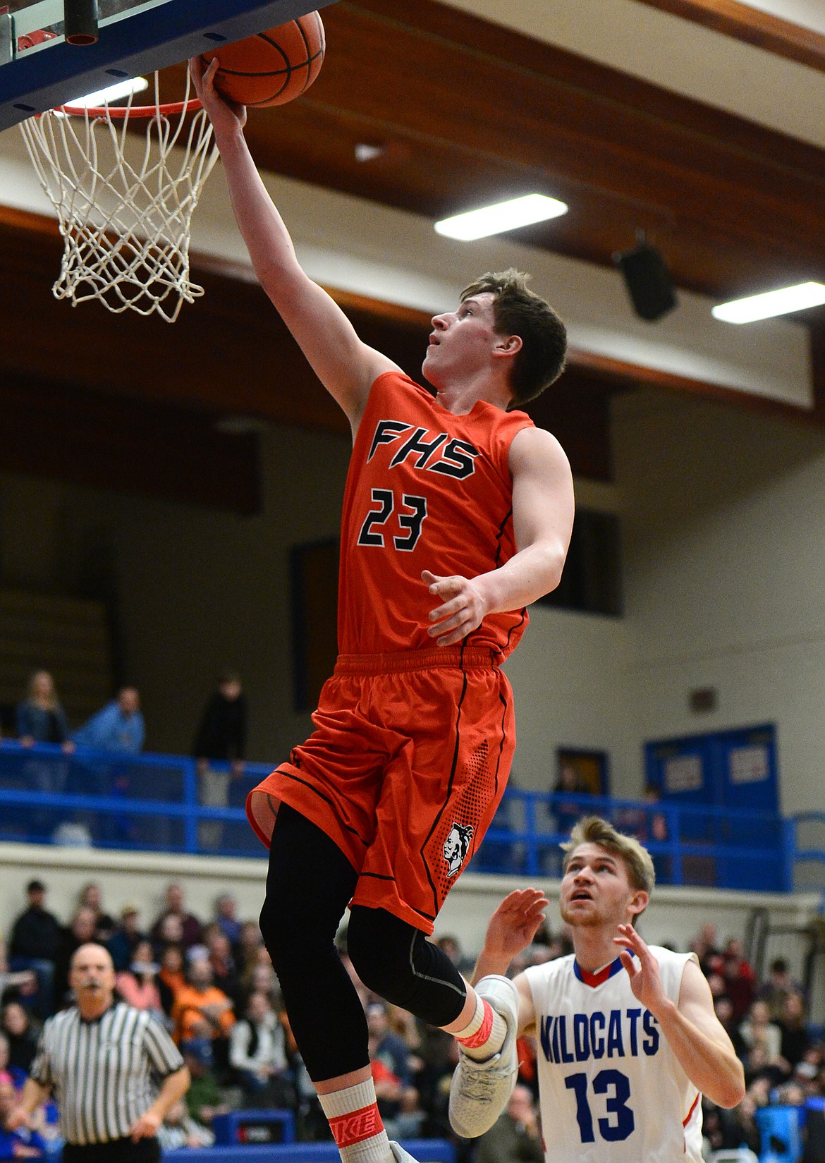 Flathead's Eric Seaman lays in two points ahead of Columbia Falls defender Lowell Panasuk. (Casey Kreider/Daily Inter Lake)