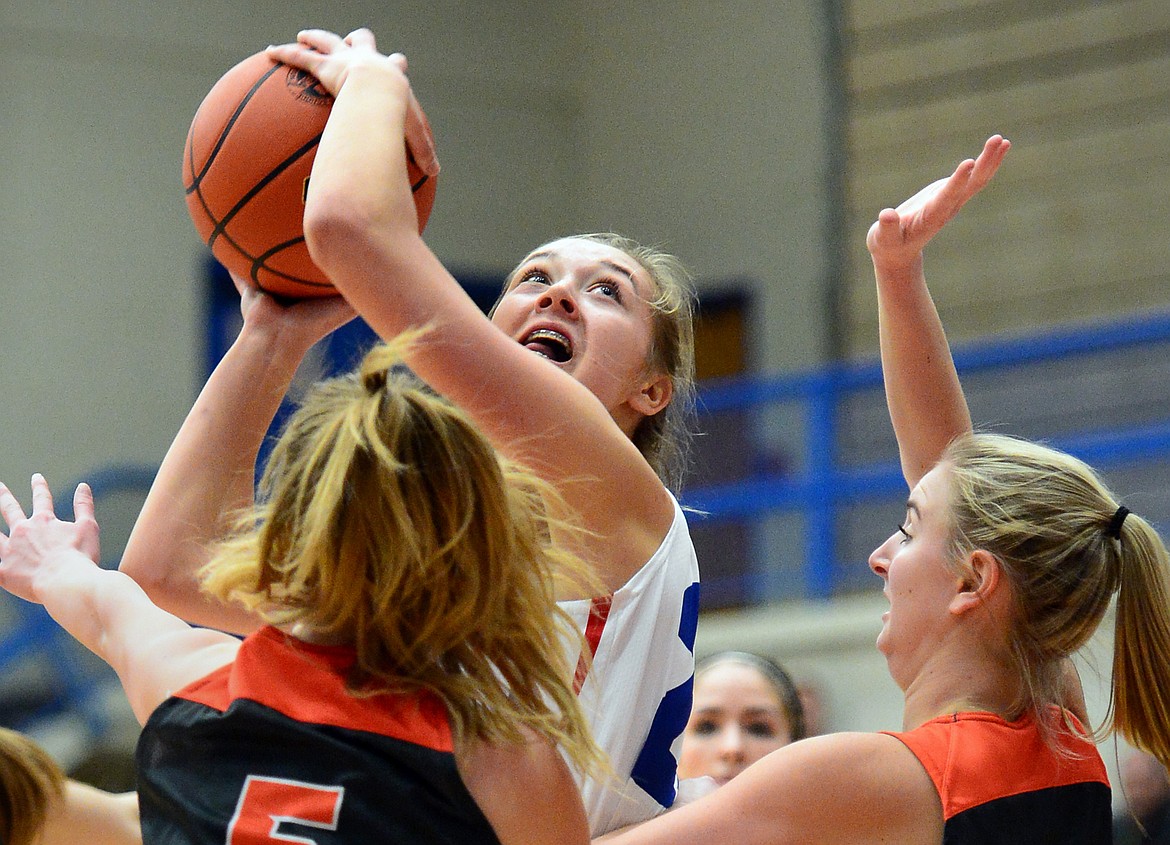 Columbia Falls' Ryley Kehr looks to shoot with Flathead's Maddie Walter, left, and Kaysie Malmin defending. (Casey Kreider/Daily Inter Lake)