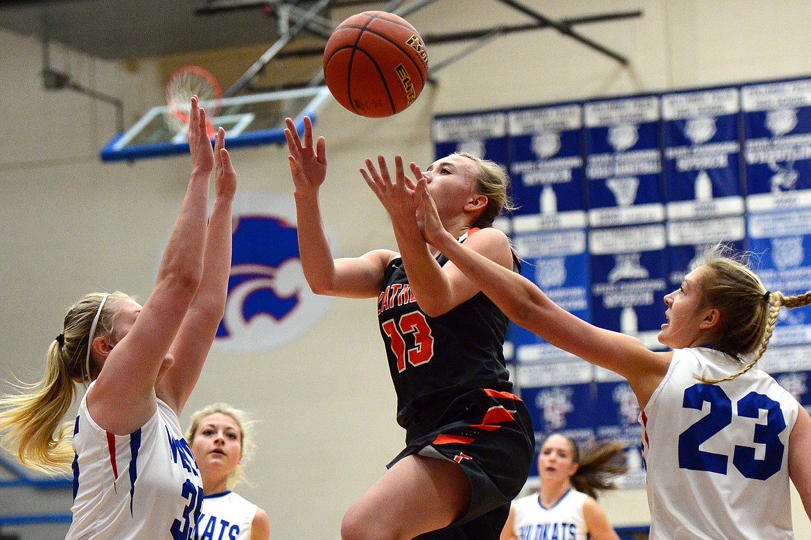 Flathead's Averie Olson is fouled by Columbia Falls' Ryley Kehr (23) on the way to the hoop. (Casey Kreider/Daily Inter Lake)