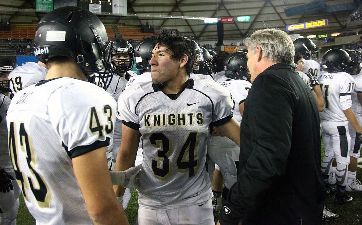 Rodney Harwood/Columbia Basin HeraldRoyal football coach Wiley Allred enjoys a moment with linebackers Jack Diaz (43) and Alonso Hernandez (34) following winning the third consecutive 1A state championship in the Tacoma Dome earlier this month.