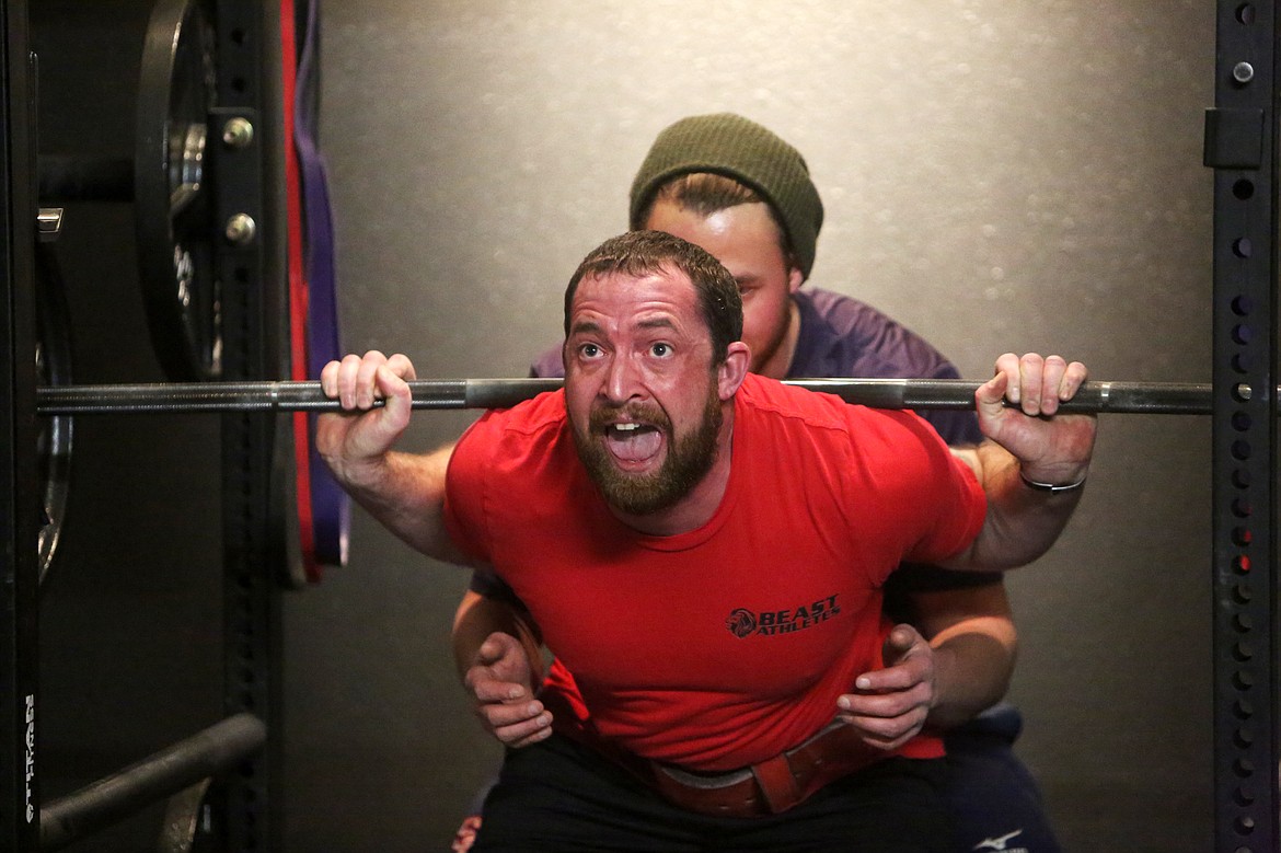 Aaron Cross, of Kalispell, lifts during squat practice for the Beast Athletes Powerlifting Team, Dec. 7. (Mackenzie Reiss/Daily Inter Lake)