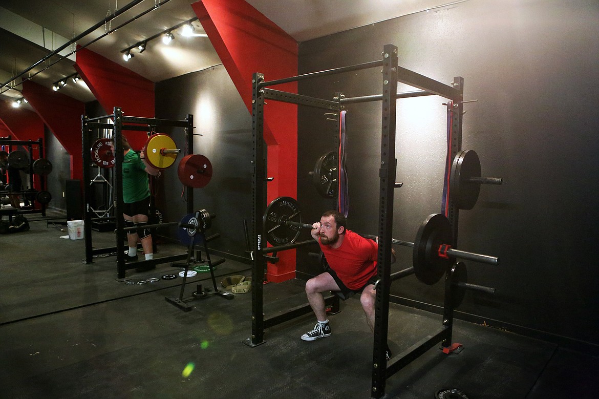 Aaron Cross, of Kalispell, squats at Beast Athletes, Dec. 7. (Mackenzie Reiss/Daily Inter Lake)