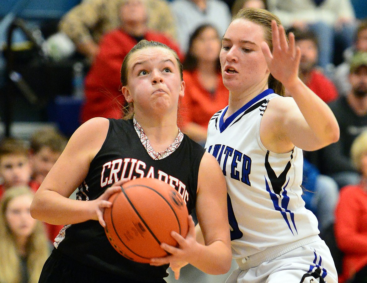 Flathead Valley Homeschool's Codi Kenney drives to the hoop against Stillwater Christian's Victoria Hanson. (Casey Kreider/Daily Inter Lake)