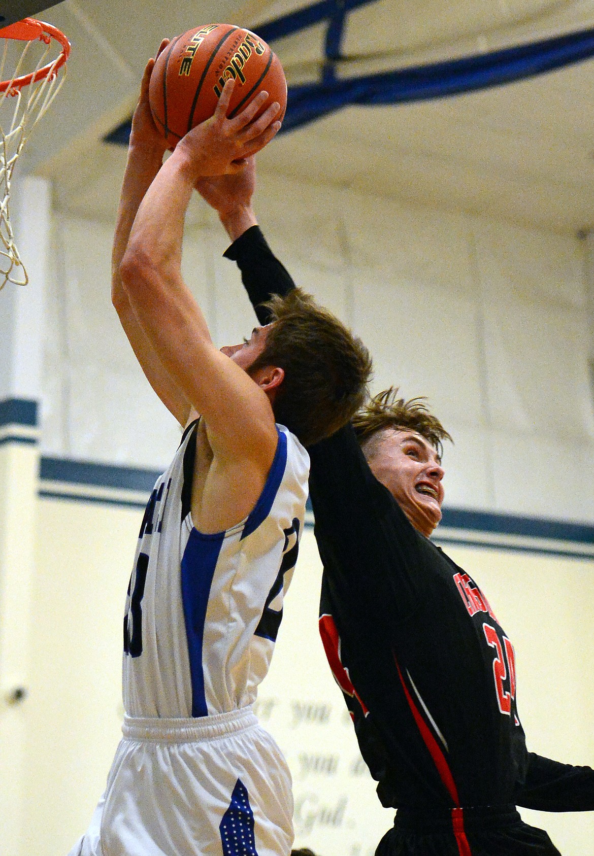 Flathead Valley Homeschool's Spencer Burden blocks a layup attempt by Stillwater Christian's Jared Fetveit. (Casey Kreider/Daily Inter Lake)