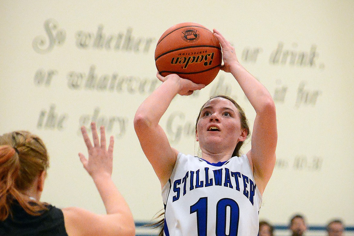 Stillwater Christian's Victoria Hanson shoots over Flathead Valley Homeschool defender Karissa Williams. (Casey Kreider/Daily Inter Lake)