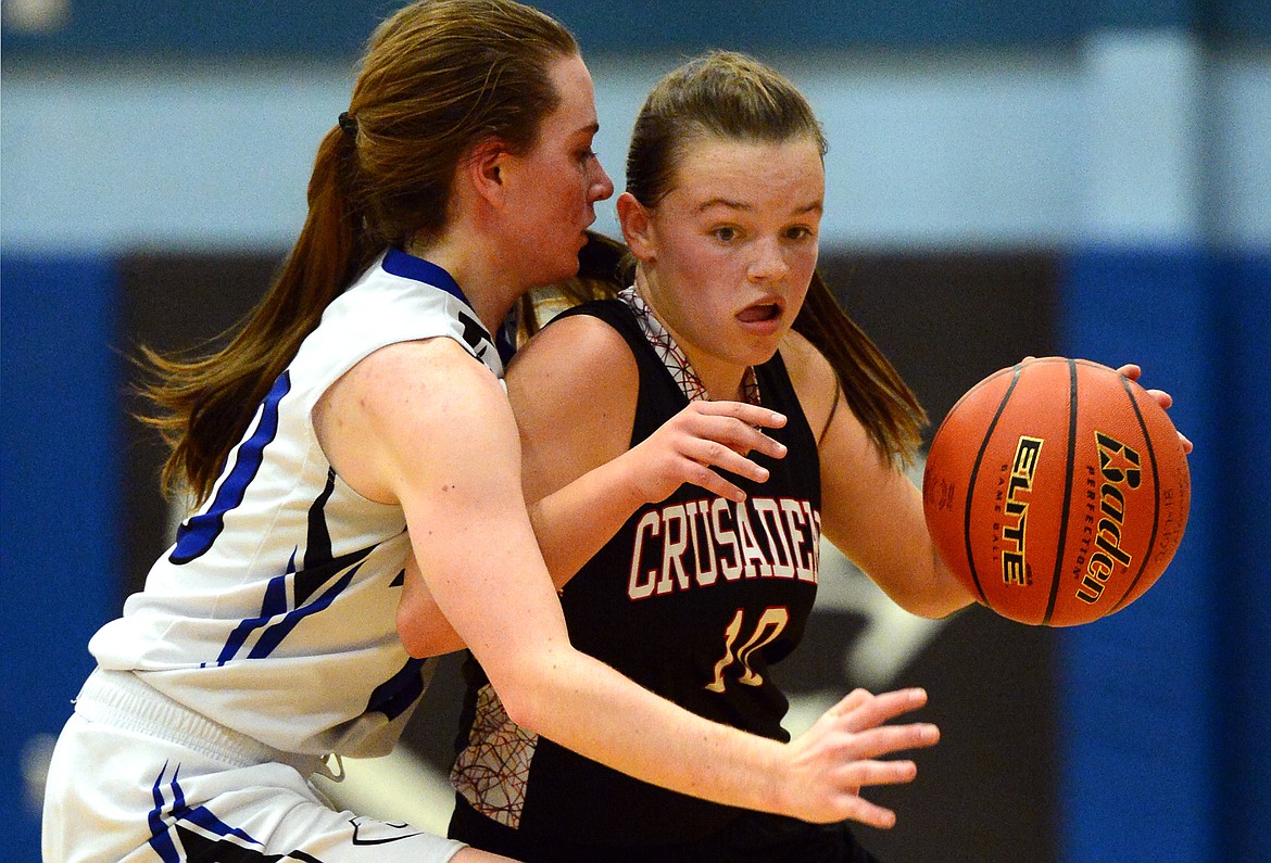 Flathead Valley Homeschool's Codi Kenney is defended by Stillwater Christian's Victoria Hanson. (Casey Kreider/Daily Inter Lake)