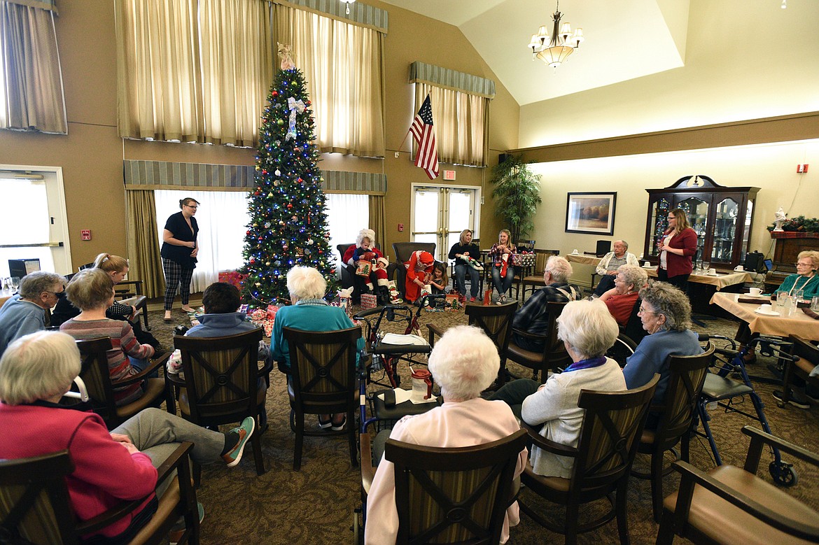 The Jaeger family opens gifts purchased by the residents at Prestige Assisted Living in Kalispell on Wednesday, Dec. 13. (Casey Kreider/Daily Inter Lake)