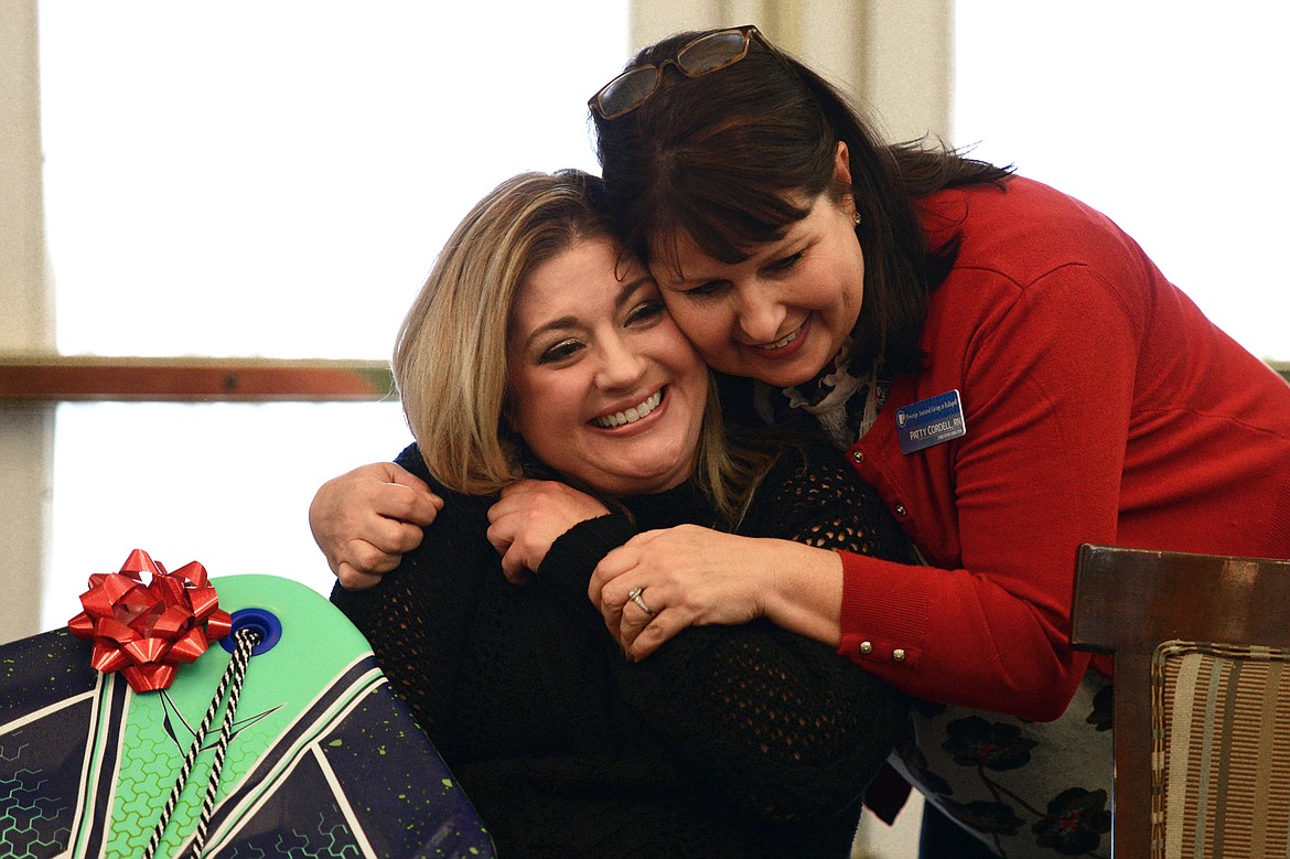 Patty Cordell, right, executive director at Prestige Assisted Living, hugs Shoni Jaeger on Wednesday.