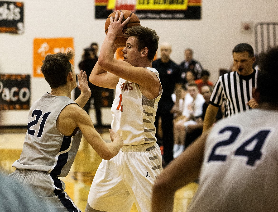 David Bourgard of Post Falls looks to pass the ball to a teammate as Gonzaga Prep&#146;s Liam Lloyd applies pressure. 
LOREN BENOIT/Press