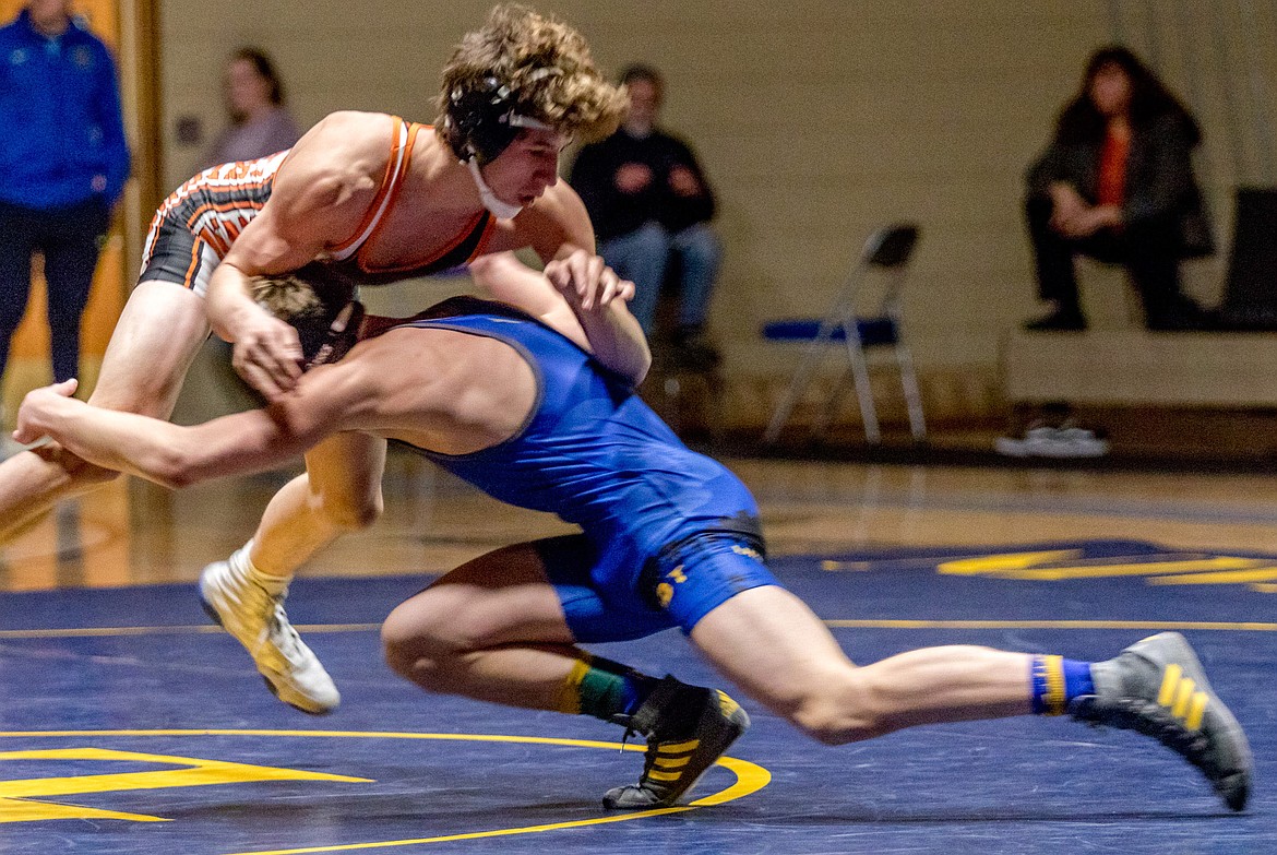 Libby&#146;s Dawson Young, right, fires towards a double leg takedown against Ronan&#146;s Seth Cheff Tuesday night at Libby High School. (John Blodgett/The Western News)
