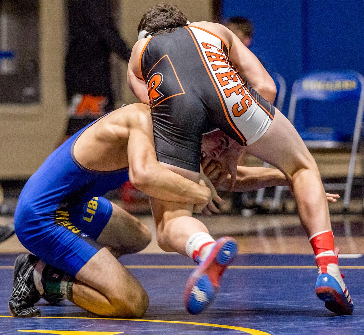 Libby&#146;s Jeff Offenbecher grapples with Ronan&#146;s Eric Dolence Tuesday night in Libby. (John Blodgett/The Western News)
