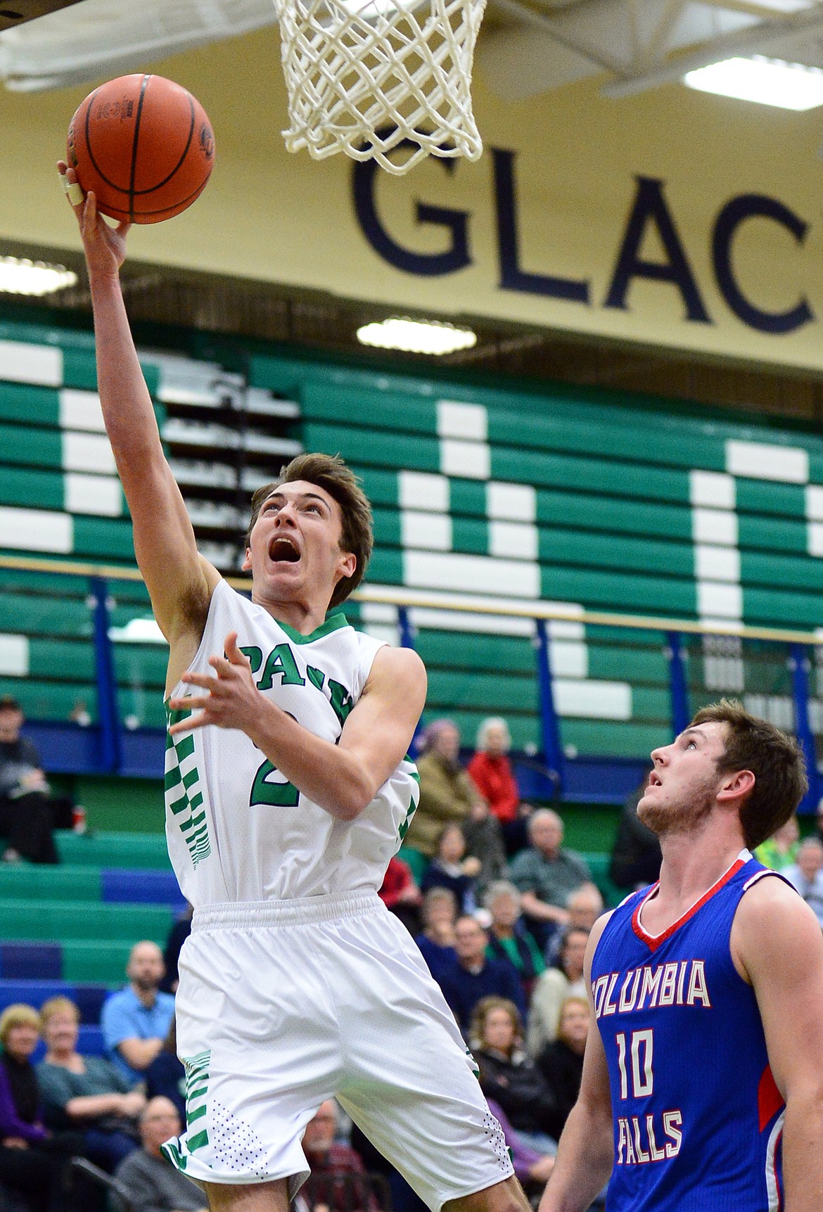 Glacier&#146;s Alex Whitman drives to the hoop in front of Columbia Falls defender Austin Green. (Casey Kreider/Daily Inter Lake)