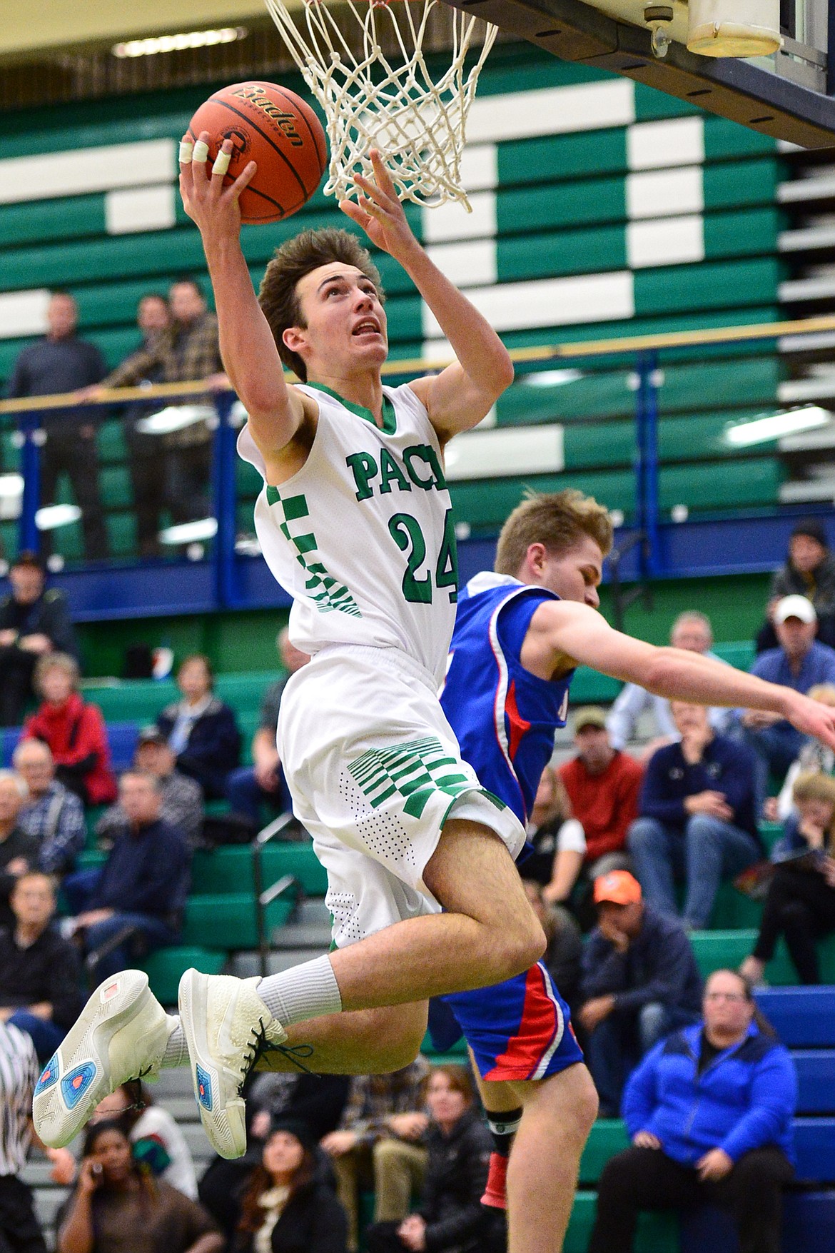 Glacier&#146;s Alex Whitman drives to the hoop past Columbia Falls defender Lowell Panasuk. (Casey Kreider/Daily Inter Lake)