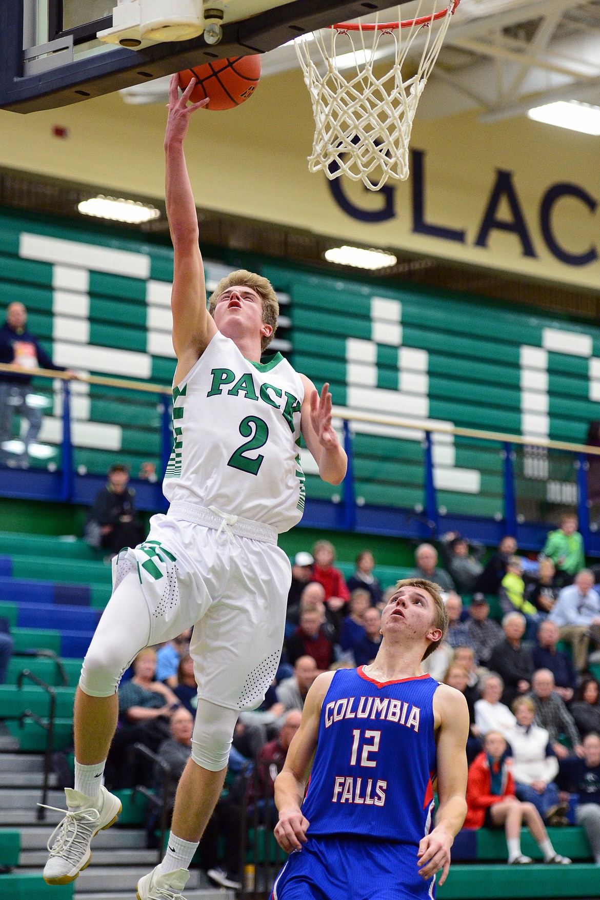 Glacier&#146;s Caden Harkins drives to the hoop in front of Columbia Falls defender Drew Morgan. (Casey Kreider/Daily Inter Lake)