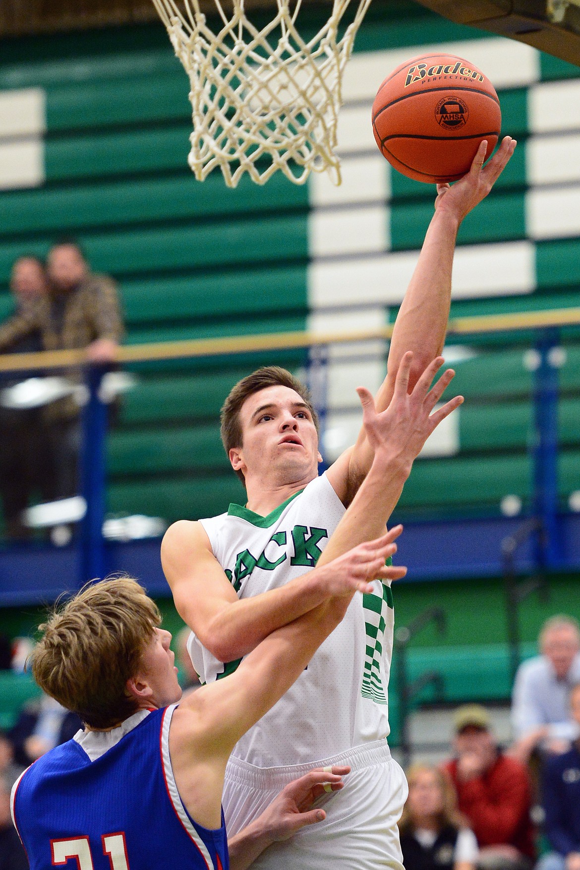 Glacier&#146;s Kody Jarvis drives to the hoop over Columbia Falls defender Matthew Morrison. (Casey Kreider/Daily Inter Lake)