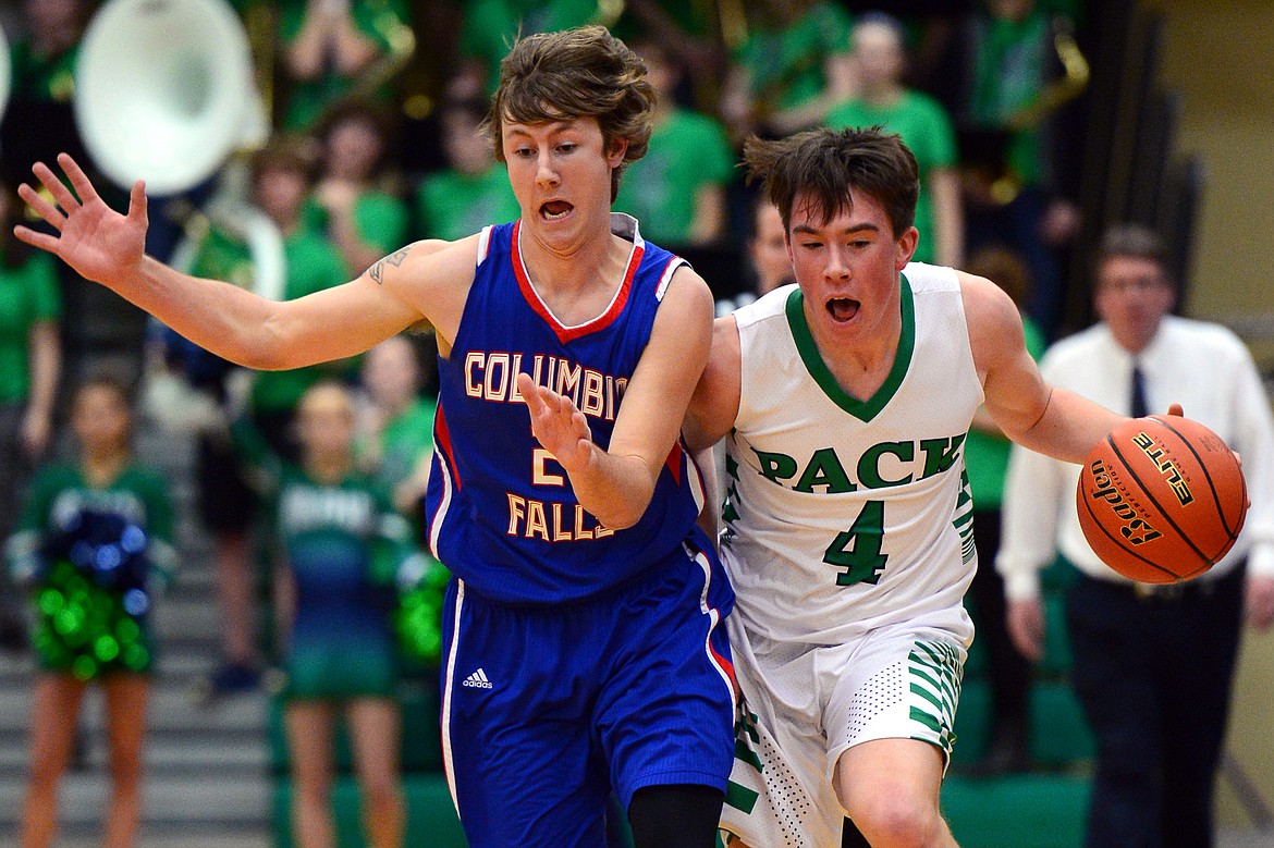 Columbia Falls&#146; Quintin Schriver, left, defends Glacier&#146;s Collin Kazmier as he brings the ball upcourt in the first quarter. (Casey Kreider/Daily Inter Lake)