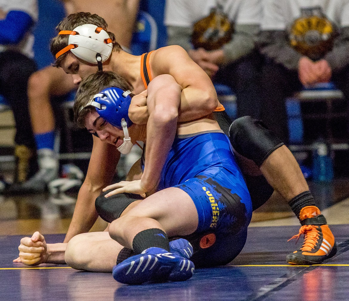 Libby&#146;s Trey Thompson, in blue, defends a leg ride from Ronan&#146;s Hunter Peterson Tuesday night at Libby High School. (John Blodgett/The Western News)