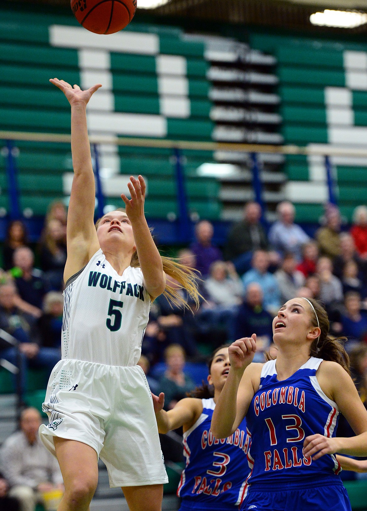 Glacier&#146;s Cadie Williams shoots over Columbia Falls defenders Dani Douglas (3) and Hannah Gedlaman. (Casey Kreider/Daily Inter Lake)