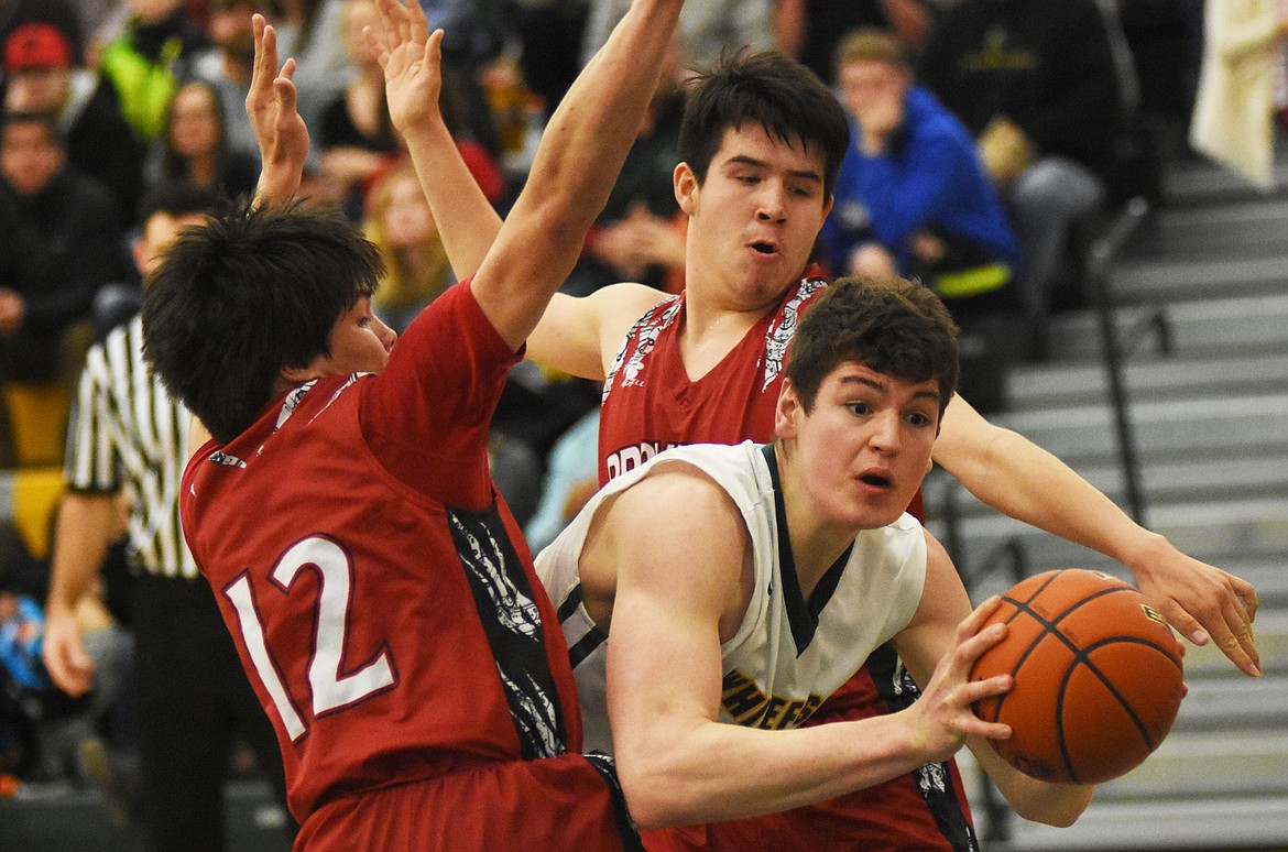 Dillon Botner is swarmed by the Browning defense on Saturday.