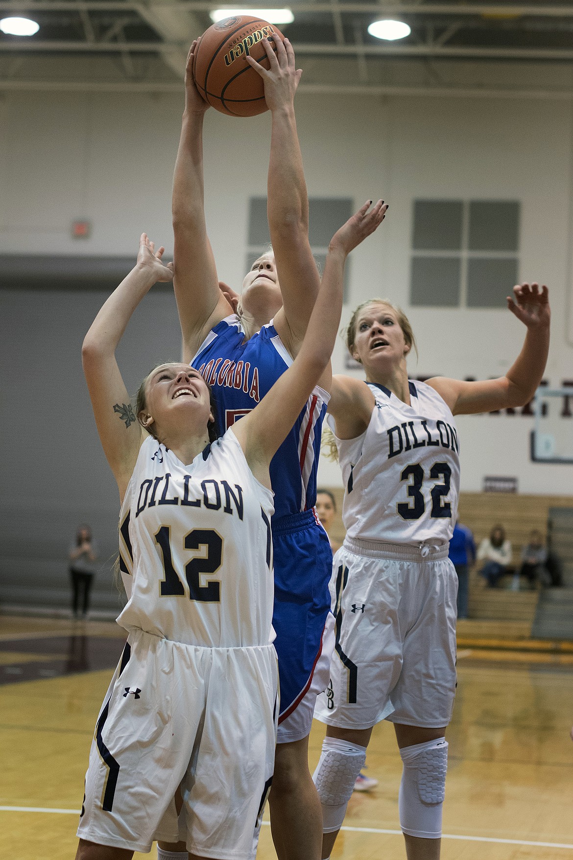 Trista Cowan pulls down a rebound over a pair of Dillon players. (Jeremy Weber photo)